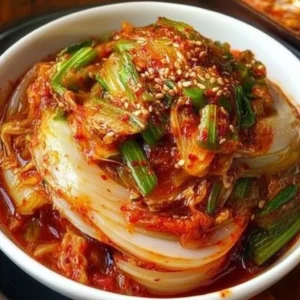 Bowl of fresh kimchi with colorful vegetables and spices