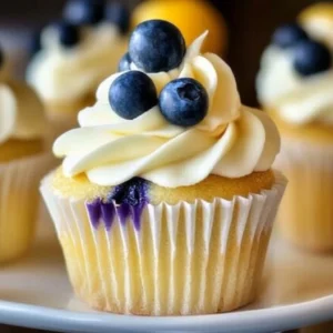 Lemon blueberry cupcakes topped with creamy frosting and fresh blueberries