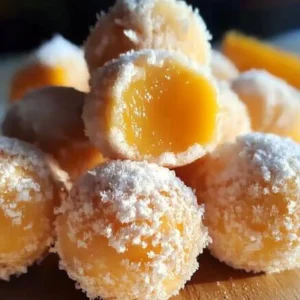 Delicious orange creamsicle truffles decorated with orange zest and white chocolate.