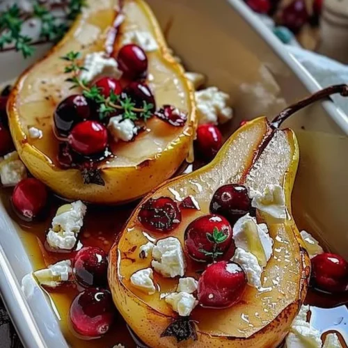 Delicious baked pears with feta cheese, honey, and cranberries on a plate.