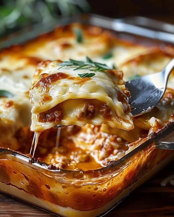 Baked Ravioli Casserole topped with cheese and herbs in a baking dish