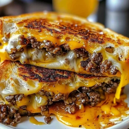 Delicious beef grilled cheese sandwich with melted cheese on toasted bread