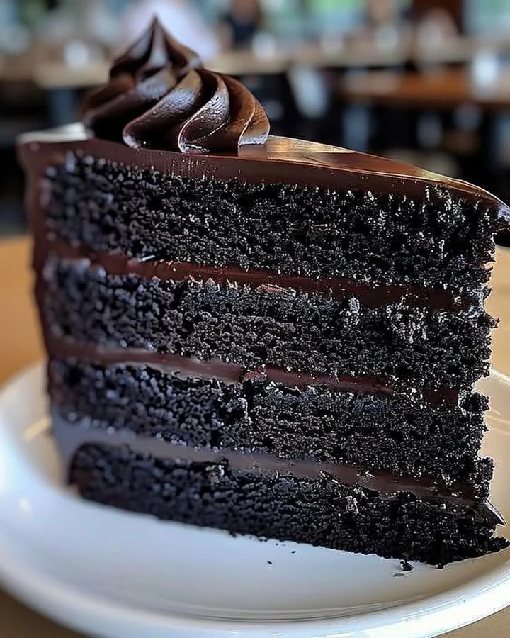Delicious slice of Black Velvet Cake with cream frosting