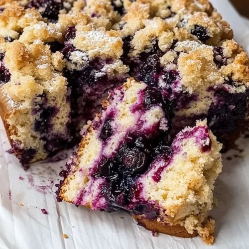 Delicious blueberry brioche crumb cake with fresh blueberries on top.