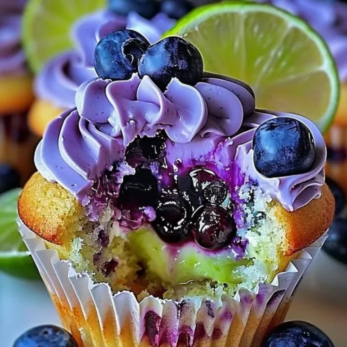 Blueberry Lime Cheesecake Cupcakes topped with blueberries and lime zest