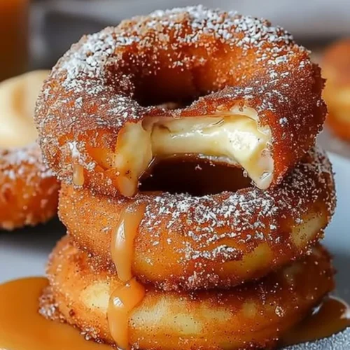 Caramel cheesecake-stuffed churro rings with a delicious cinnamon sugar coating.