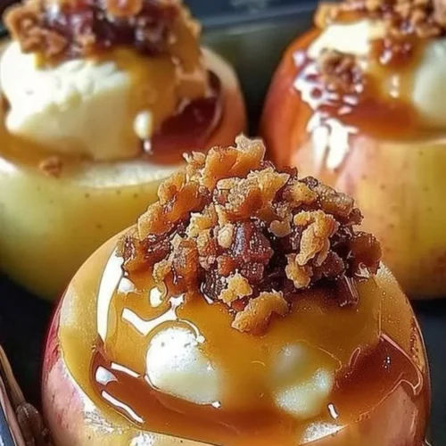 Baked apples stuffed with rich cheesecake filling, a delightful dessert.