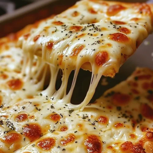 Freshly baked Cheesy Breadsticks served with marinara sauce
