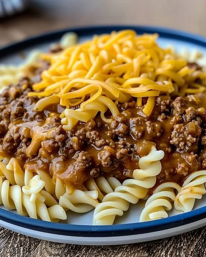 Delicious bowl of cheesy sloppy cheeseburger pasta topped with fresh herbs.