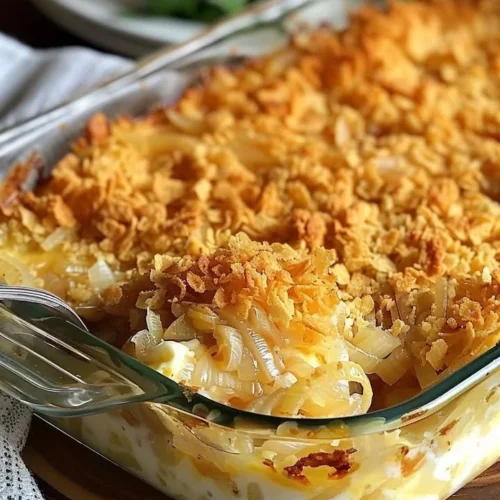 Cheesy Vidalia onion casserole dish topped with melted cheese and herbs