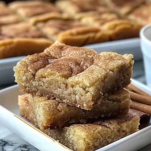 Chewy snickerdoodle cookie bars topped with cinnamon sugar.