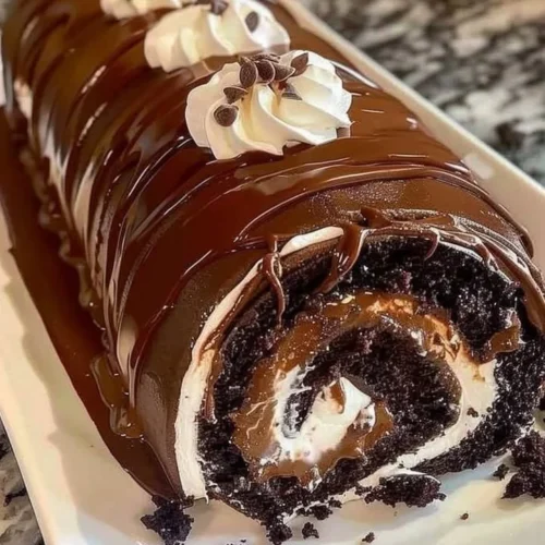 Delicious rolled chocolate cake with creamy filling on a plate