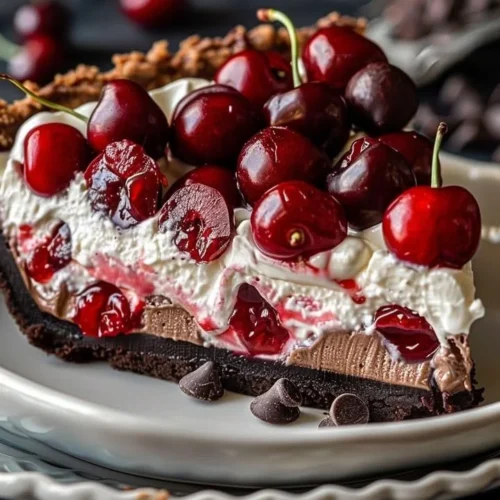 Chocolate Cherry Cream Pie topped with whipped cream and cherry garnish