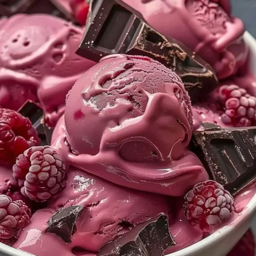 Delicious Crimson Cocoa Rhapsody ice cream in a bowl with chocolate swirls.