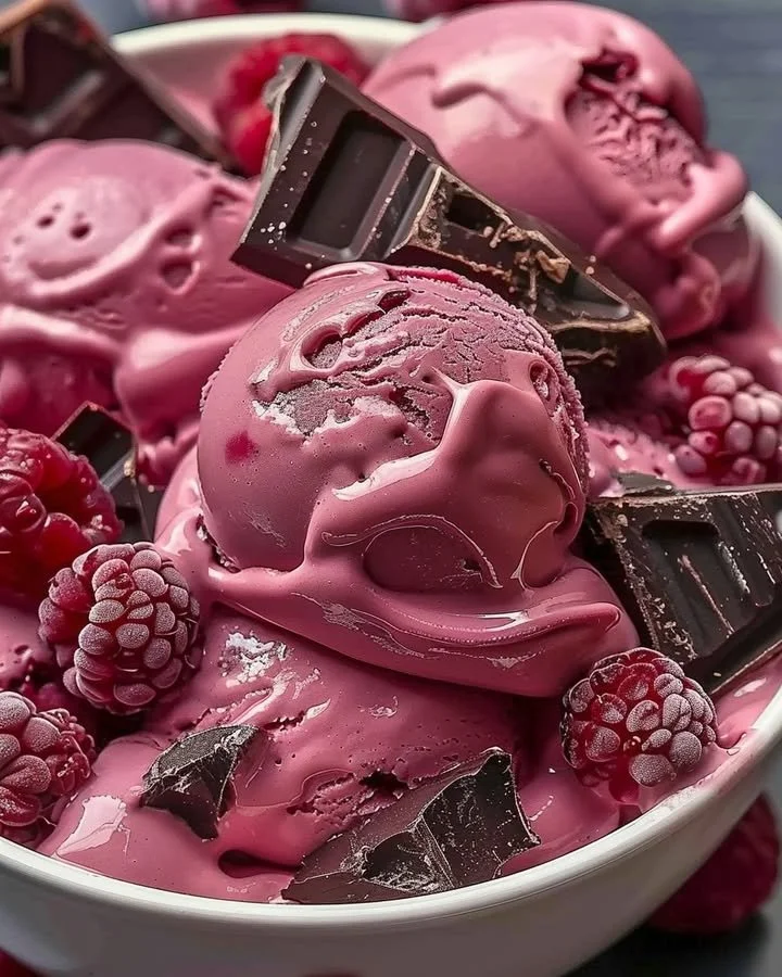 Delicious Crimson Cocoa Rhapsody ice cream in a bowl with chocolate swirls.