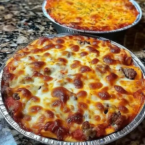 Delicious crustless pizza bowl filled with cheese, vegetables, and toppings.