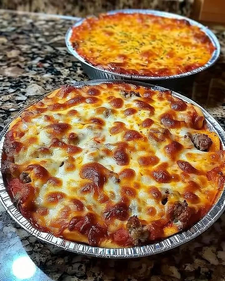 Delicious crustless pizza bowl filled with cheese, vegetables, and toppings.