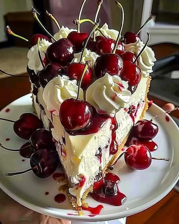 Sliced elegant cherry cheesecake topped with fresh cherries