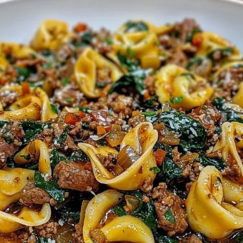 Delicious Garlic Butter Beef Tortellini with Spinach in a white bowl