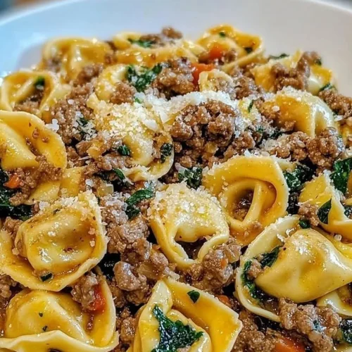 Delicious Garlic Butter Beef Tortellini served in a bowl with herbs.