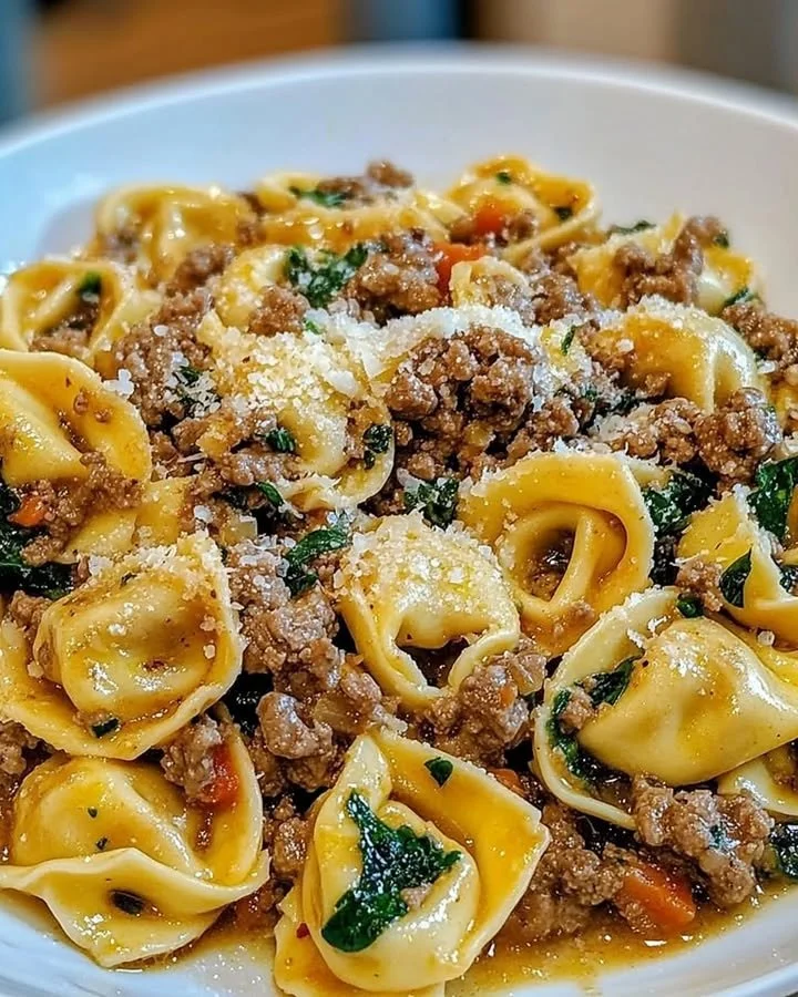 Delicious Garlic Butter Beef Tortellini served in a bowl with herbs.