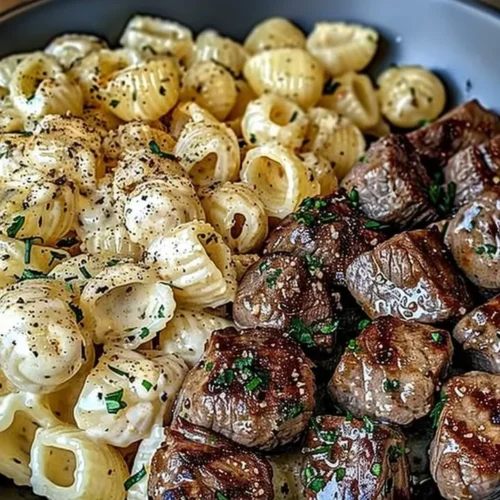 Delicious Garlic Butter Steak Bites served alongside creamy Parmesan pasta shells.