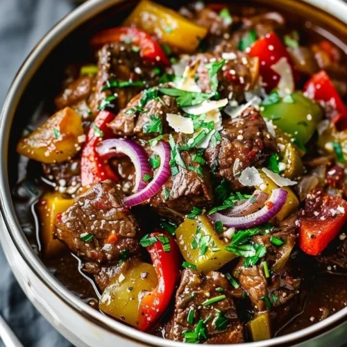 A bowl of hearty Guinness Braised Beef Stew garnished with herbs.