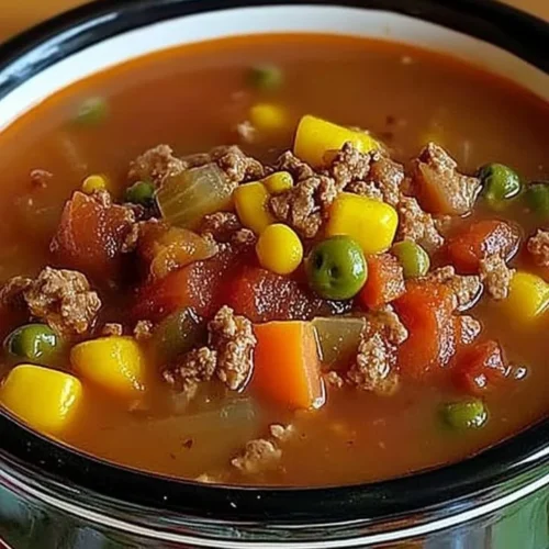 Bowl of hearty crock pot cowboy soup with vegetables and beans
