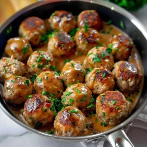 Delicious Swedish meatballs in a creamy sauce served on a plate.