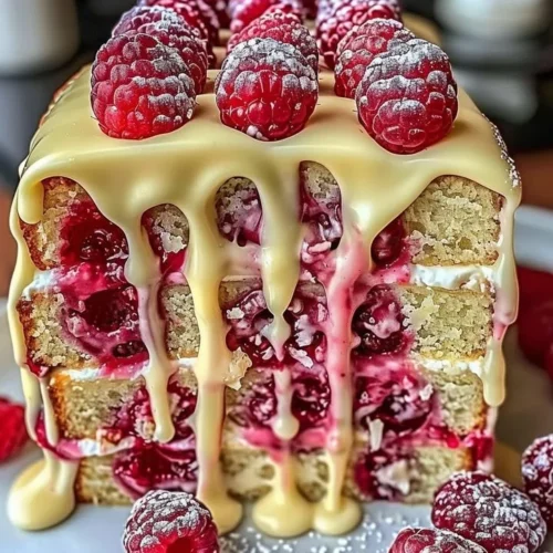 Heavenly White Chocolate Raspberry Cake with fresh raspberries on top