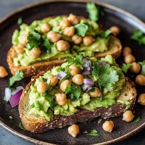 High protein vegan avocado toast topped with seeds and herbs on whole grain bread