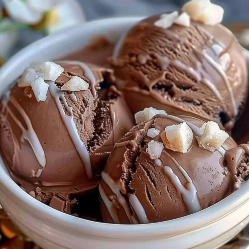 A bowl of creamy homemade chocolate ice cream with chocolate shavings on top.