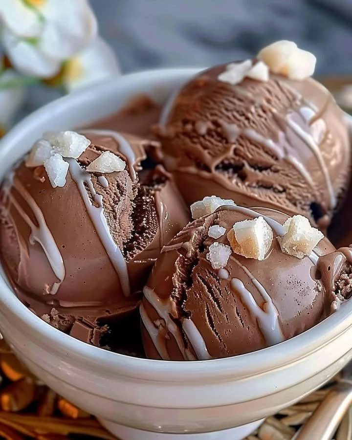 A bowl of creamy homemade chocolate ice cream with chocolate shavings on top.