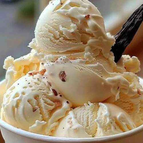 Bowl of creamy homemade vanilla ice cream served with toppings