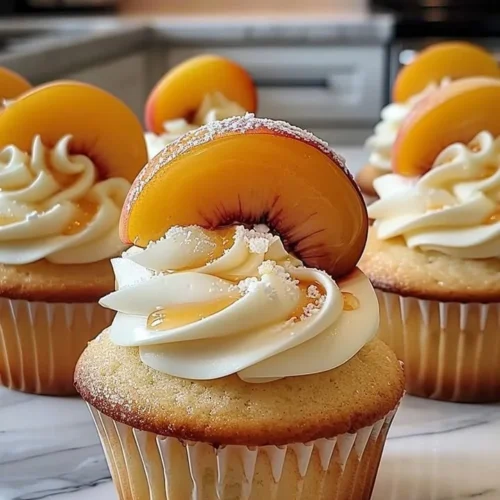 Delicious Honey Peach Cream Cheese Cupcakes topped with creamy frosting.