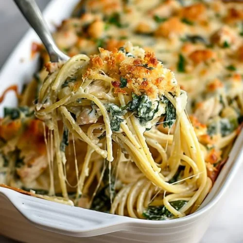 Monterey Chicken Spaghetti Bake topped with cheese and herbs