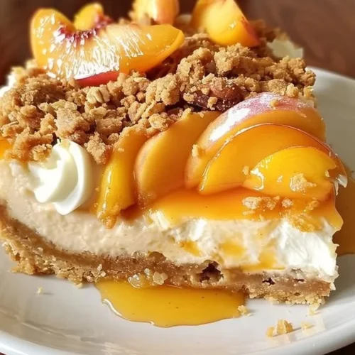 Delicious Peach Cobbler Cheesecake with peach slices and crumb topping