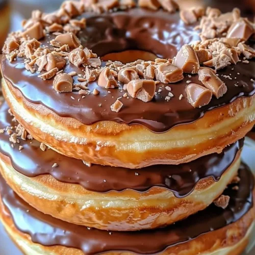 Peanut Butter Reese’s Donut Sandwiches with chocolate drizzle and sprinkles