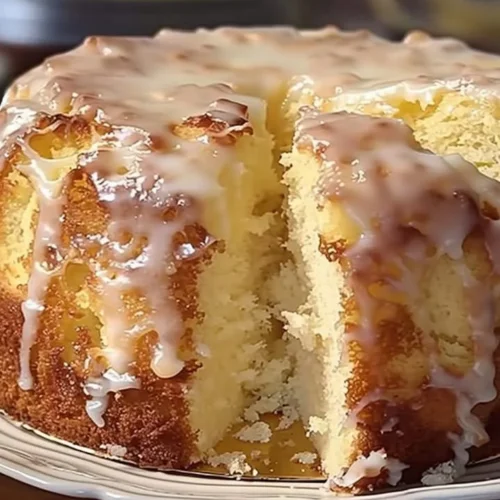 Deliciously moist Pina Colada Pound Cake topped with coconut and pineapple.