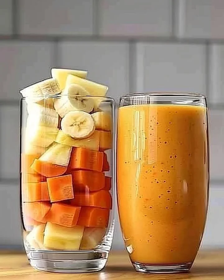 Pineapple Orange Carrot Smoothie in a glass with fresh ingredients