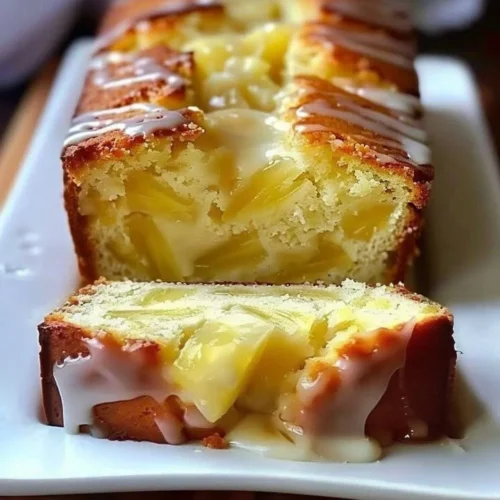 Slice of homemade pineapple quick bread on a wooden board