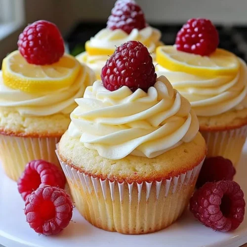 Delicious Raspberry Lemon Cupcakes topped with fresh raspberries and lemon frosting.