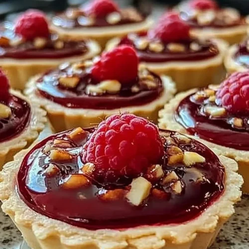 Delicious Raspberry Rhapsody Tarts made with fresh raspberries and flaky pastry.