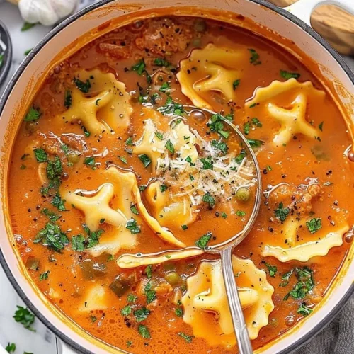 One pot Ravioli Soup served in a bowl with fresh herbs on top