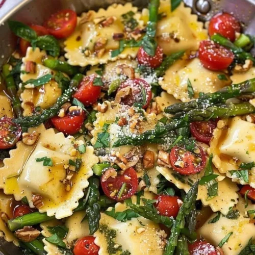 Delicious ravioli served with tomatoes, asparagus, and herbs.