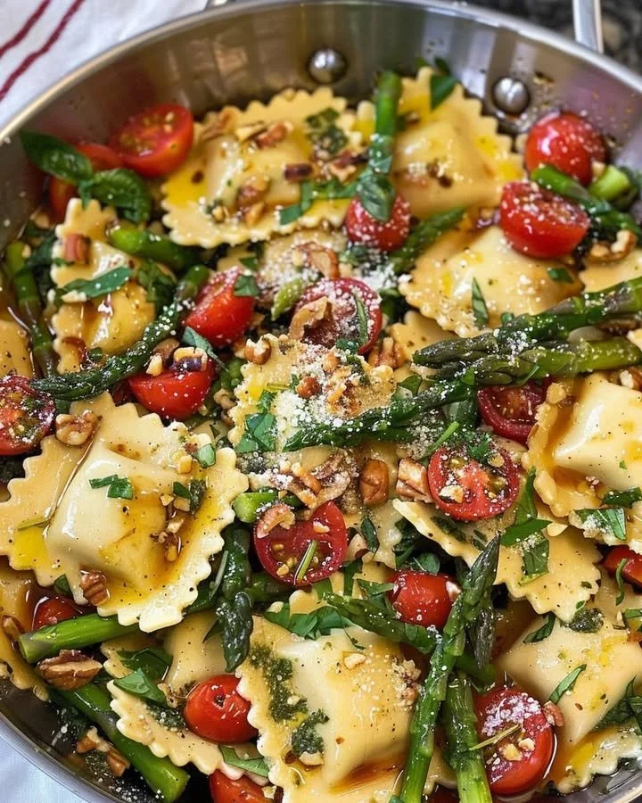Delicious ravioli served with tomatoes, asparagus, and herbs.
