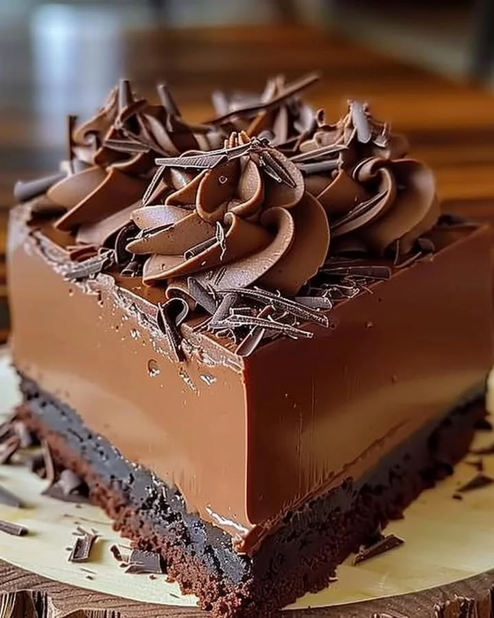 Decadent rich chocolate mousse cake layered with creamy chocolate topping