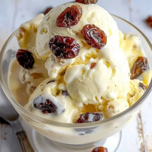 Delicious bowl of rum raisin ice cream with raisins and a hint of rum flavor.