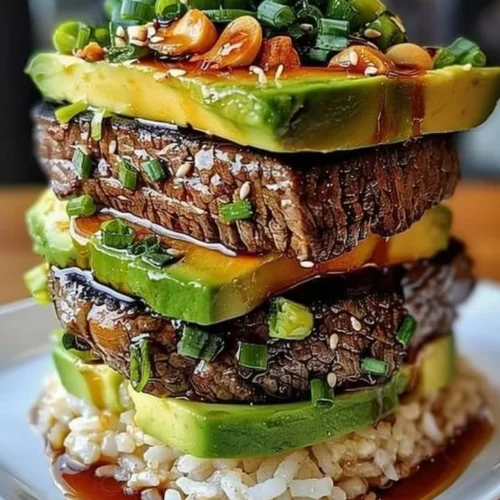 Delicious Teriyaki Beef and Avocado Rice Stack beautifully arranged on a plate.