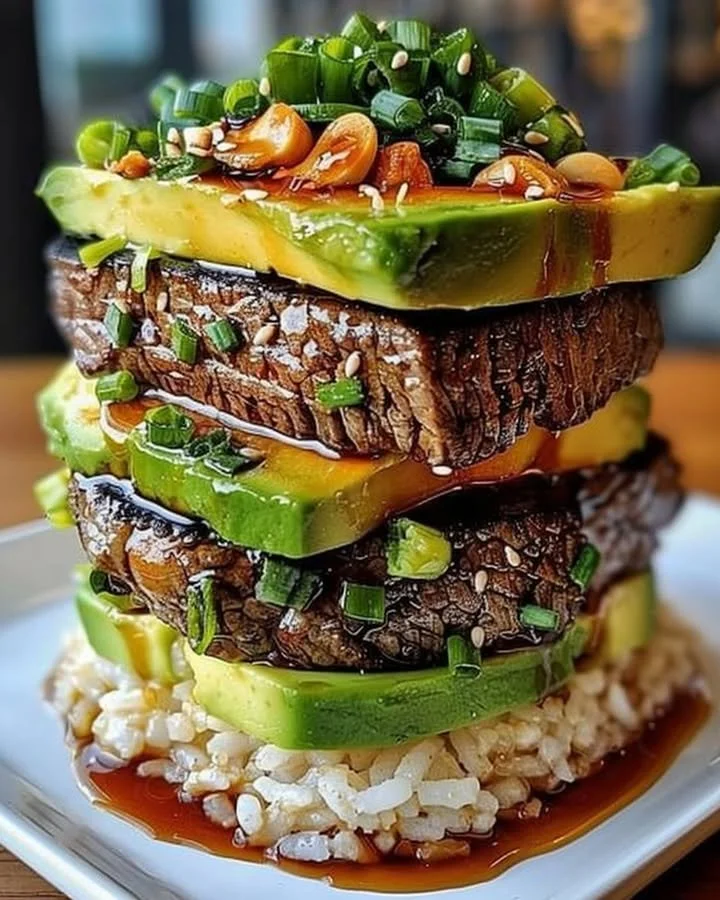Delicious Teriyaki Beef and Avocado Rice Stack beautifully arranged on a plate.